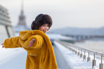 Portrait of happy woman in red faux fur coat in winter outdoors