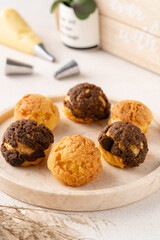 Choux pastry  is a delicate pastry dough used in many pastries. It contains only butter, water, flour, and eggs. Choux pastries are sometimes filled with cream after baking to make cream puffs 