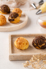 Choux pastry  is a delicate pastry dough used in many pastries. It contains only butter, water, flour, and eggs. Choux pastries are sometimes filled with cream after baking to make cream puffs 
