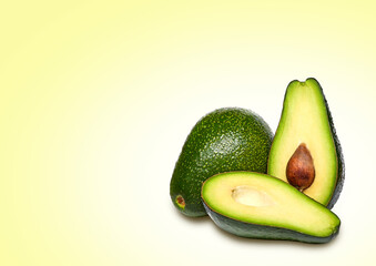 Composition of ripe avocados on a bright background.