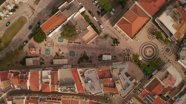 Aerial birds eye overhead top down view of Gil Eanes square in Lagos, Algarve, Portugal, drone rising up, day