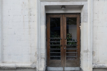 Fototapeta na wymiar old wooden doors and white wall