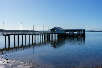 Morning view from the shoreline, to the Victoria Point jetty, reflected in the calm water of Moreton Bay 