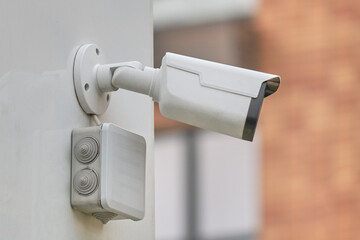 Video surveillance camera on the window building, monitoring the security of a residential house