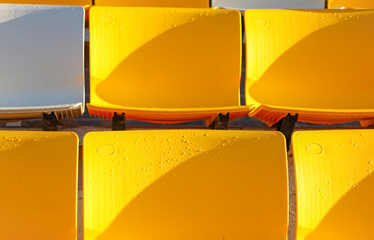 full frame of yellow sports stadium seating