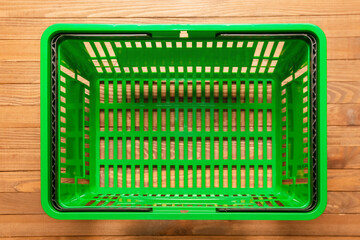 Shopping basket on wooden background