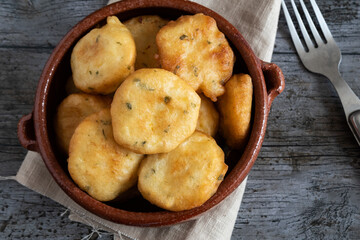 Homemade fried zucchini fritters on rustic background