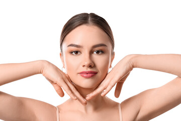 Beautiful young woman massaging her face on white background