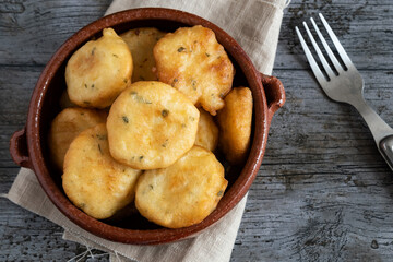 Homemade fried zucchini fritters on rustic background