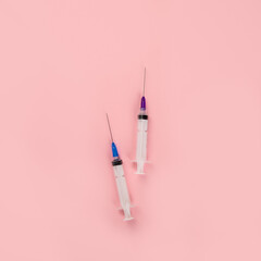 Syringes placed on pink background. Medical concept and vaccination.