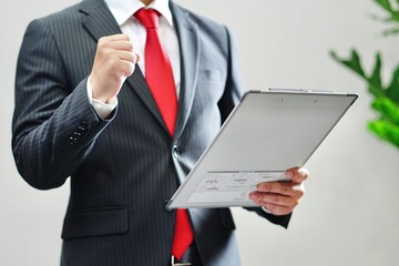 バインダーを持つ日本人ビジネスマン