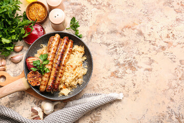 Frying pan with tasty sauerkraut, grilled sausages and sauces on grunge background