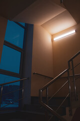 Fototapeta premium Atmospheric staircase at night with a dim Atmospheric