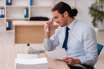 Young male employee working in the office