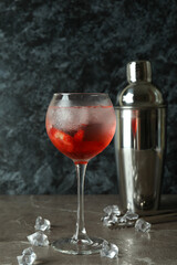 Shaker and glass of fresh summer cocktail on gray table