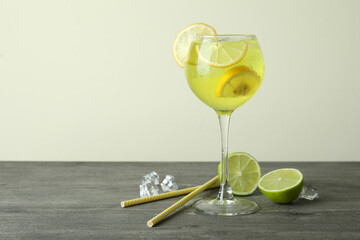 Glass of fresh citrus cocktail on gray table