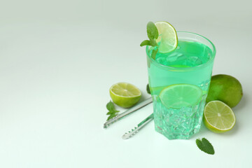 Fresh lime cocktail and ingredients on white background