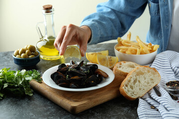 Concept of delicious food with mussels on black smokey table