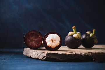 Peeled mangosteen fruit on wooden with blue color background, Tropical fruit