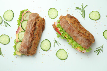 Ciabatta sandwiches and ingredients on white background