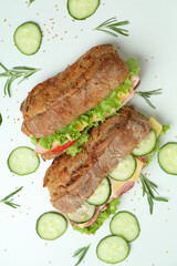 Ciabatta sandwiches and ingredients on white background