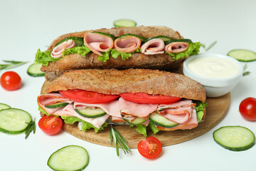 Concept of tasty eating with ciabatta sandwiches on white background