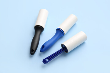 Different lint rollers on color background