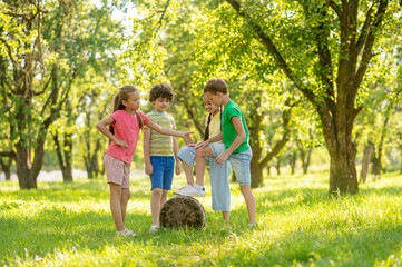 Cheerful boys and girls playing in park