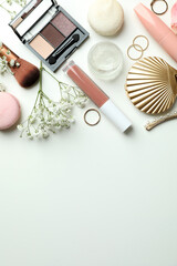 Female accessories and macaroons on white background