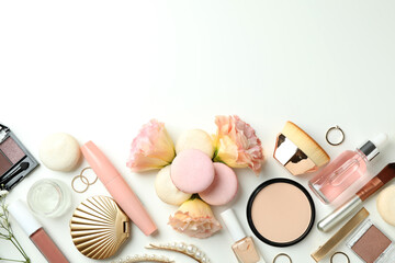 Female accessories and macaroons on white background