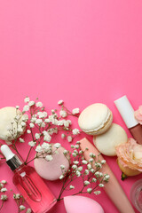 Female accessories and macaroons on pink background