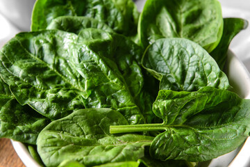 Bowl with fresh spinach leaves, closeup