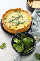 Tasty spinach tart on light background