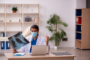 Young male doctor radiologist wearing face-mask during pandemic