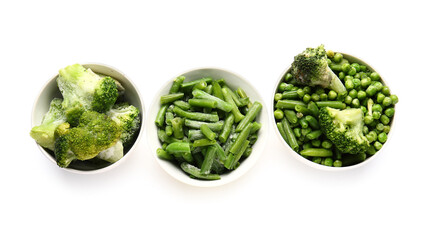 Bowls with frozen green vegetables on white background