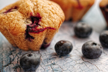 Close up of homemade blueberry muffin, on rustic blue wooden table
