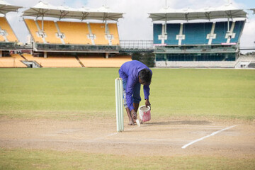 Groundsman making the crease before a match