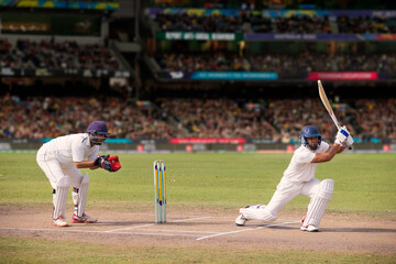 Cricketer batsman ready to hit a shot during a match on the pitch