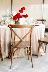 Fototapeta na wymiar Cross back wooden chair in rustic style in wedding decor