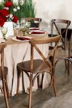 Vintage wooden wedding chairs. Cross in the back of the chair