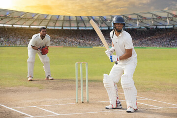 Cricketer batsman at the crease waiting for the ball.