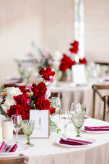 Served festive table with tap napkins and green goblets and glasses. Wedding decor and table decorations