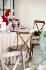 Festive rustic wooden chairs. Cross in the back of the chair