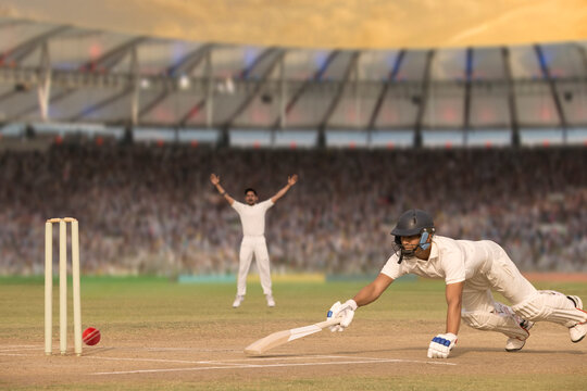 Batsman diving while taking a run during a match