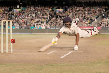 Batsman diving while taking a run during a match