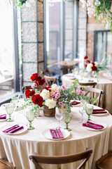 Served festive table with tap napkins and green goblets and glasses. Wedding decor and table decorations