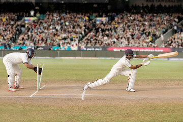 Batsman is Stumped by Wicket Keeper During a match in the stadium - obrazy, fototapety, plakaty