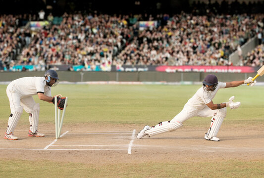 Batsman is Stumped by Wicket Keeper During a match in the stadium