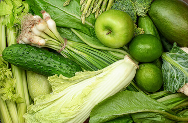 background of a variety of green fruits and vegetables close up