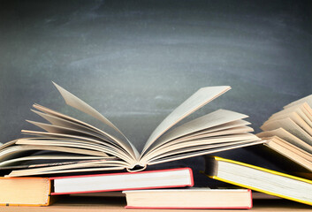 books on chalkboard background, education concept